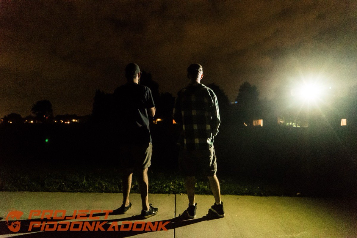 Two people and one work light, somewhere past midnight.