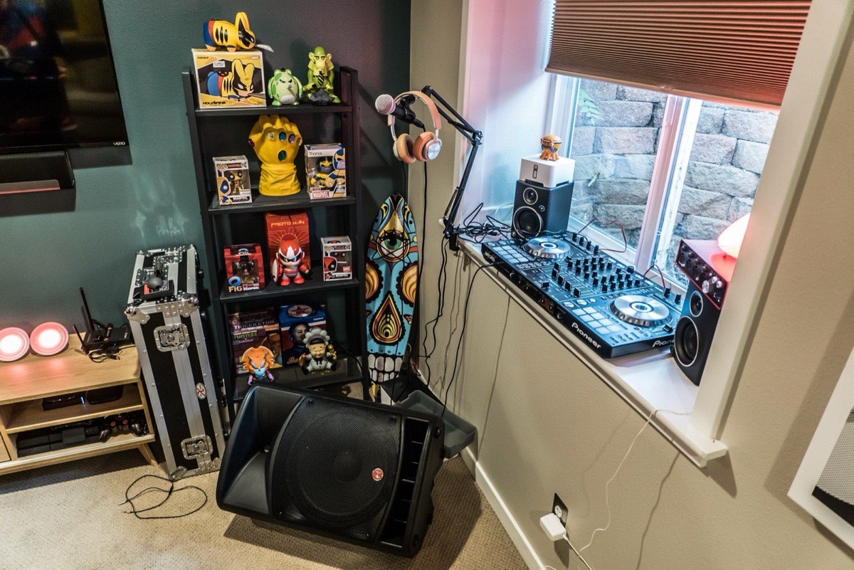 A corner of gear, decks and toys under a window